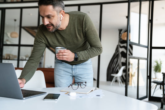 A man sitting in his home office without artwork to boost his productivity