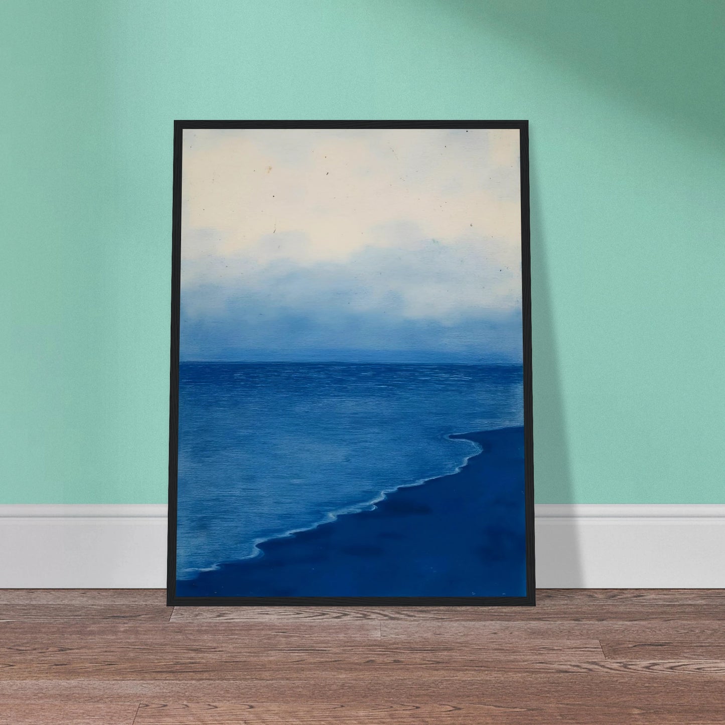 A calm, blue shoreline fades into the horizon under a soft, cloudy sky, evoking peace and solitude.