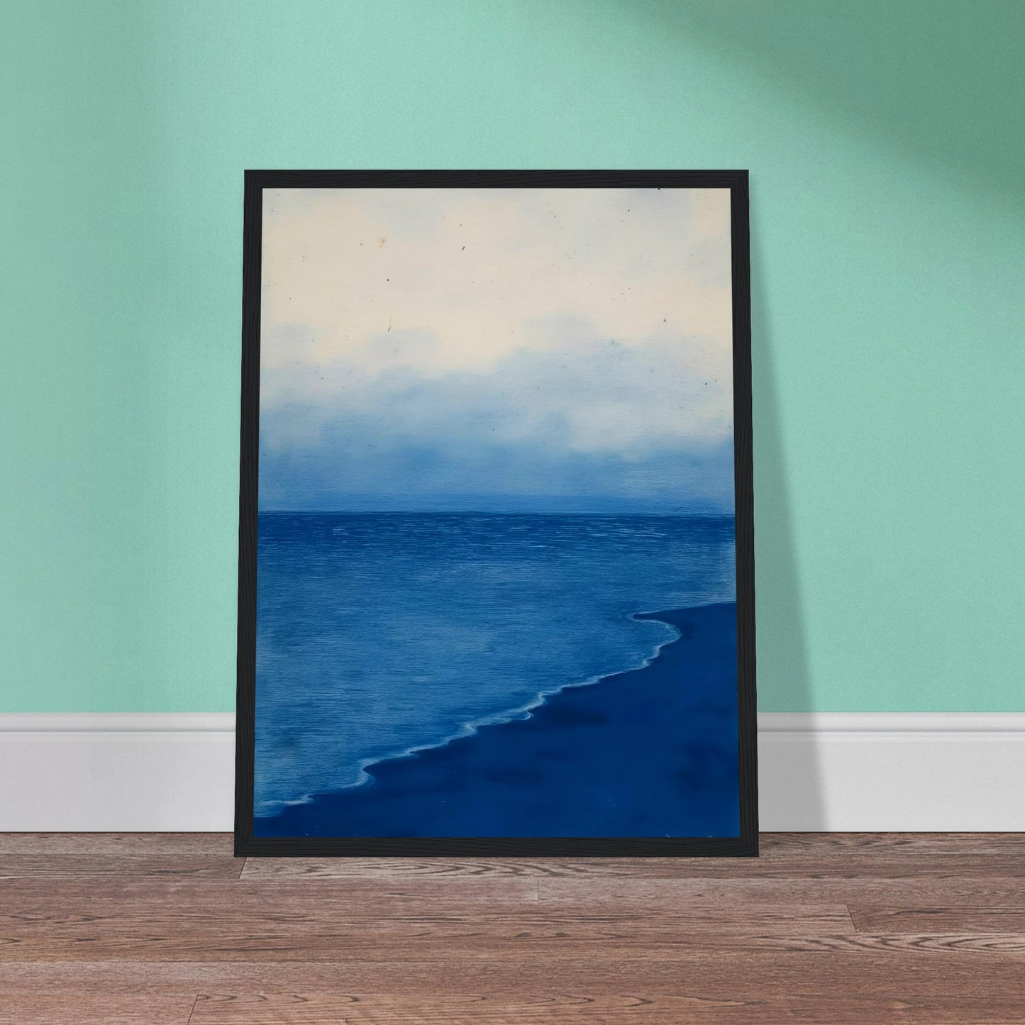A calm, blue shoreline fades into the horizon under a soft, cloudy sky, evoking peace and solitude.