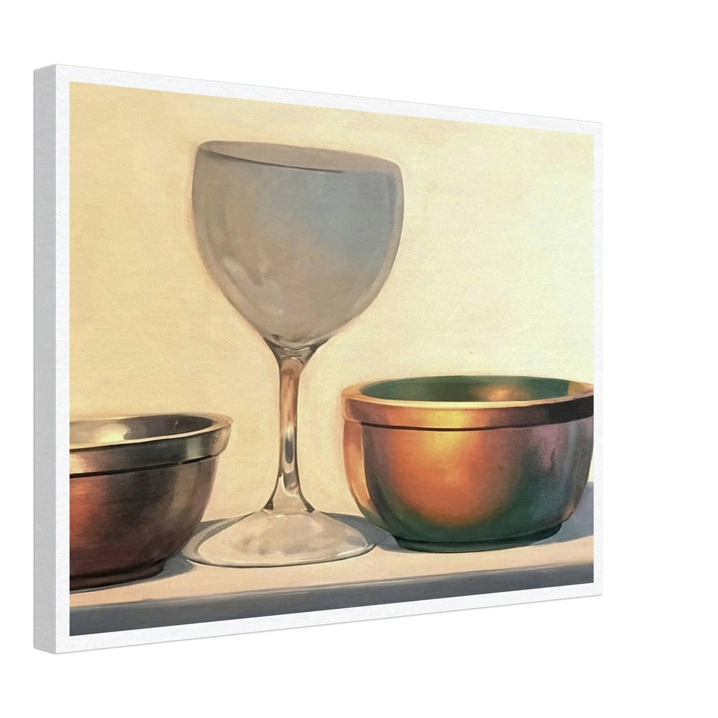 A glass chalice and two metallic bowls arranged in soft light, highlighting their reflective surfaces in a subtle, elegant composition.