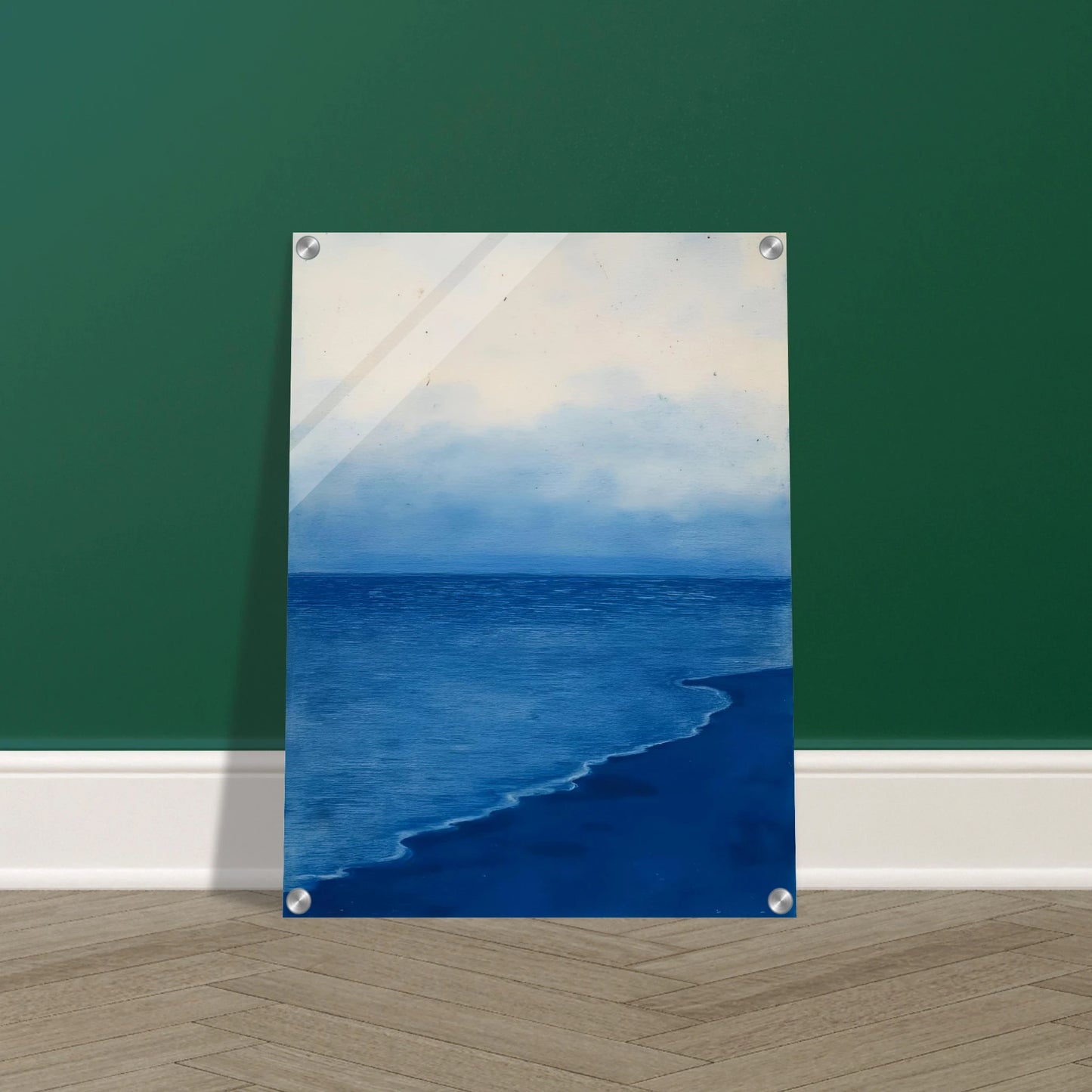 A calm, blue shoreline fades into the horizon under a soft, cloudy sky, evoking peace and solitude.