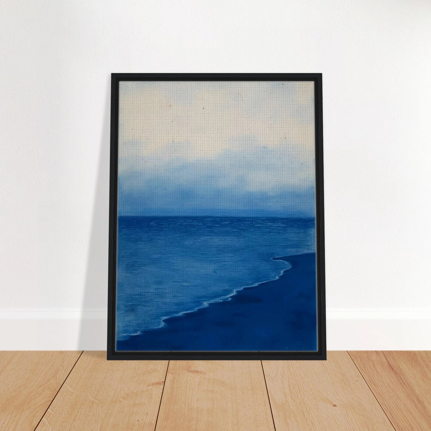 A calm, blue shoreline fades into the horizon under a soft, cloudy sky, evoking peace and solitude.