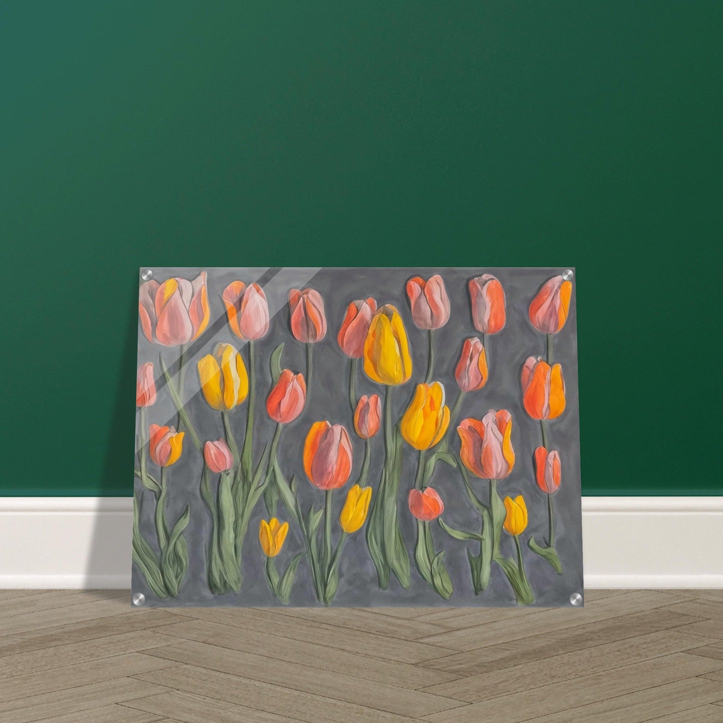 A charming display of orange and yellow tulips standing tall against a muted gray background, showcasing their vibrant colors and graceful stems.