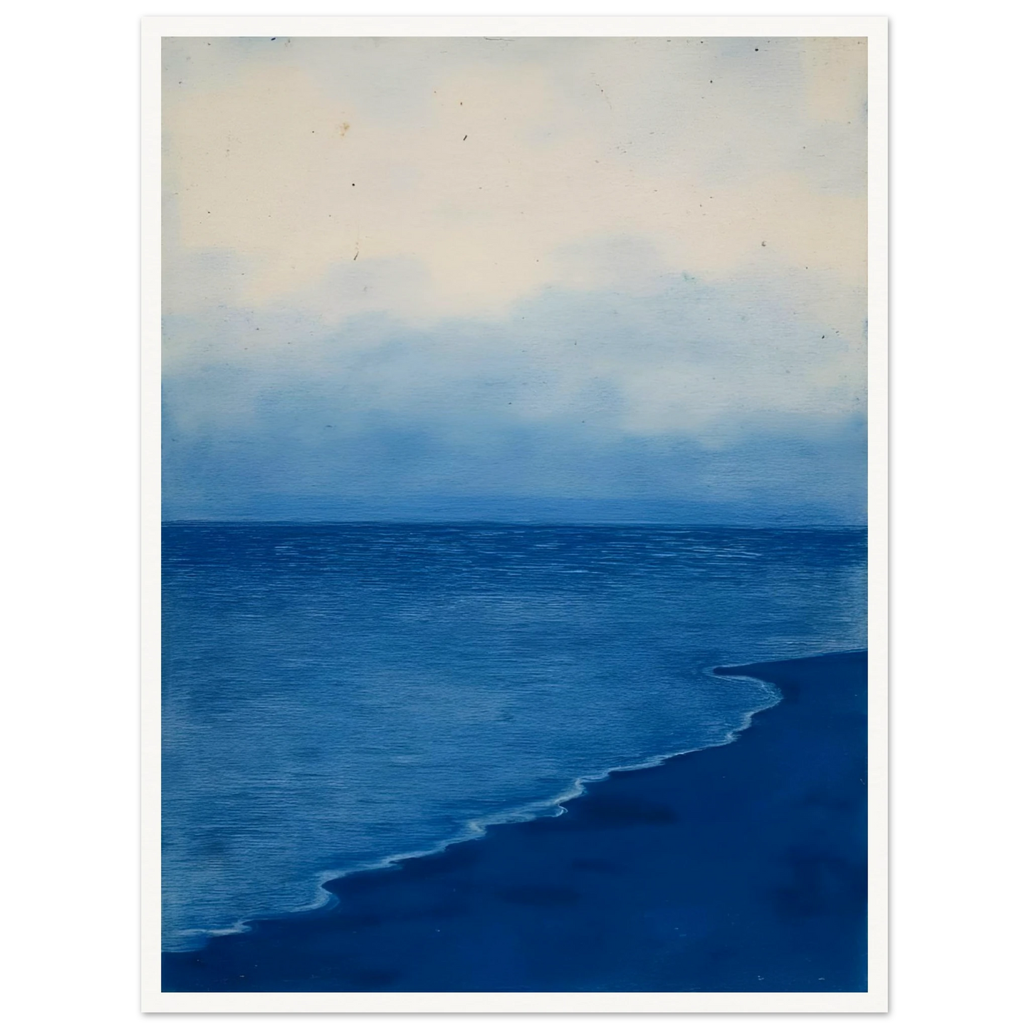 A calm, blue shoreline fades into the horizon under a soft, cloudy sky, evoking peace and solitude.