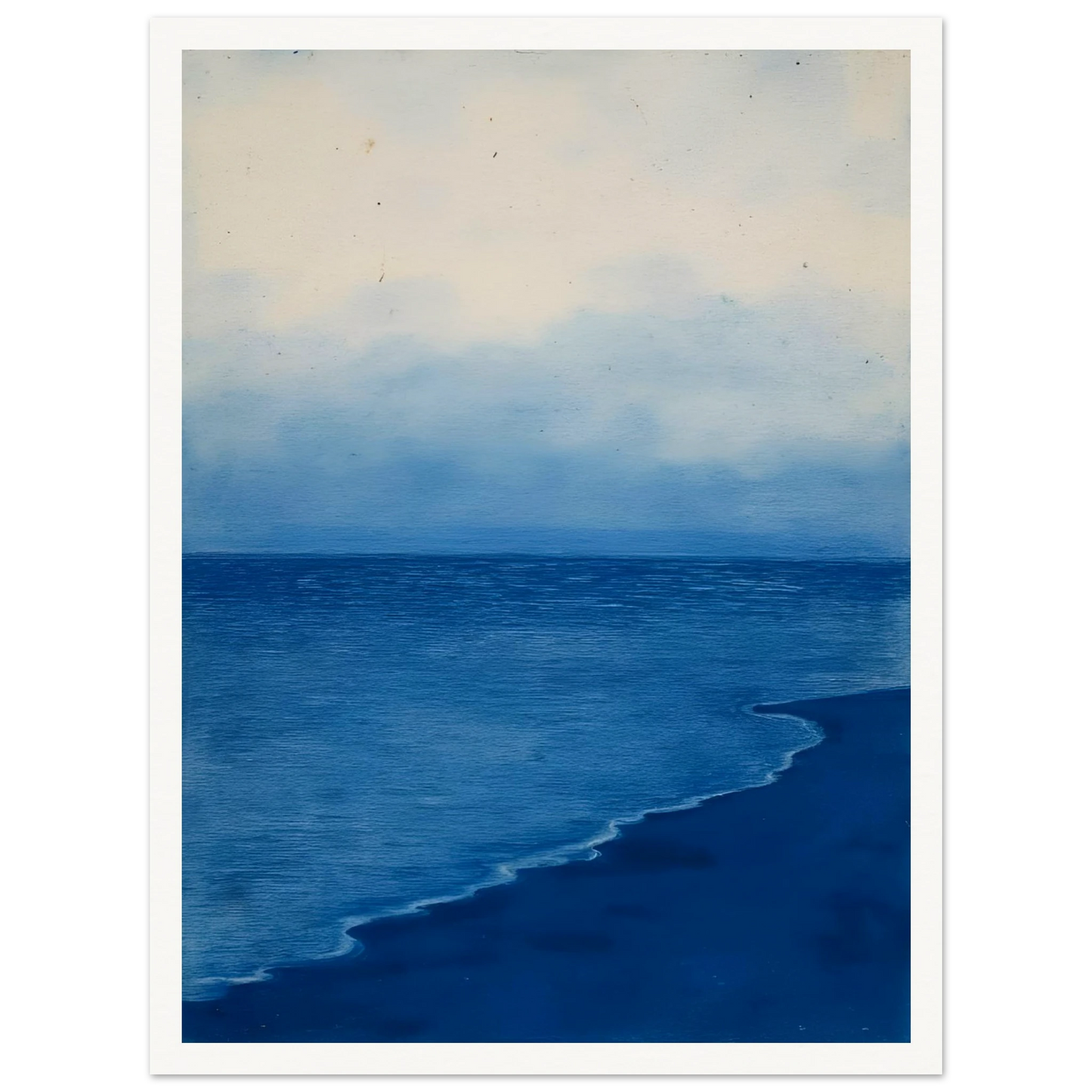 A calm, blue shoreline fades into the horizon under a soft, cloudy sky, evoking peace and solitude.