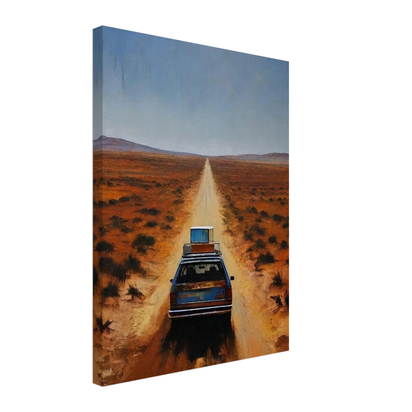 A car driving down a long, desolate road in a vast desert landscape under a clear blue sky.