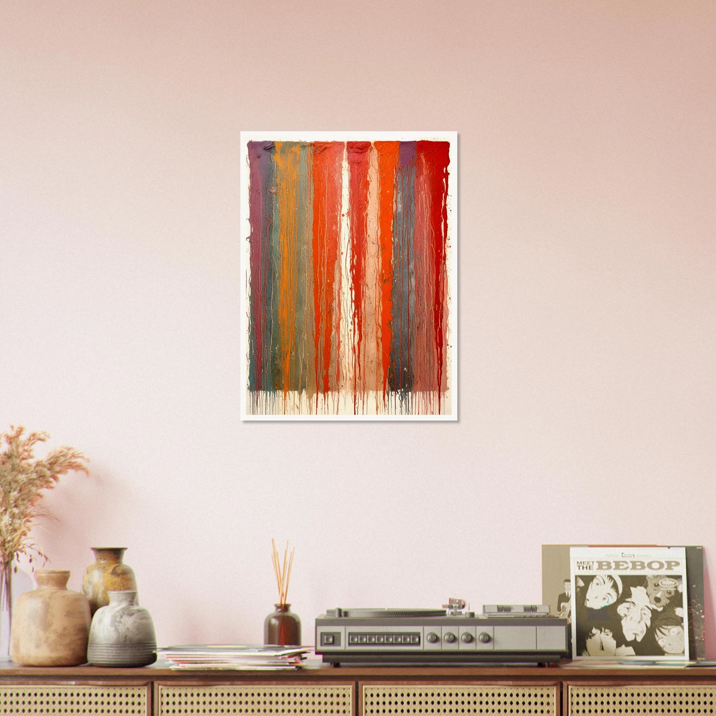 Vertical ribbons of vibrant paint drip down the canvas in layered red, orange, blue, and purple tones against a pale backdrop.