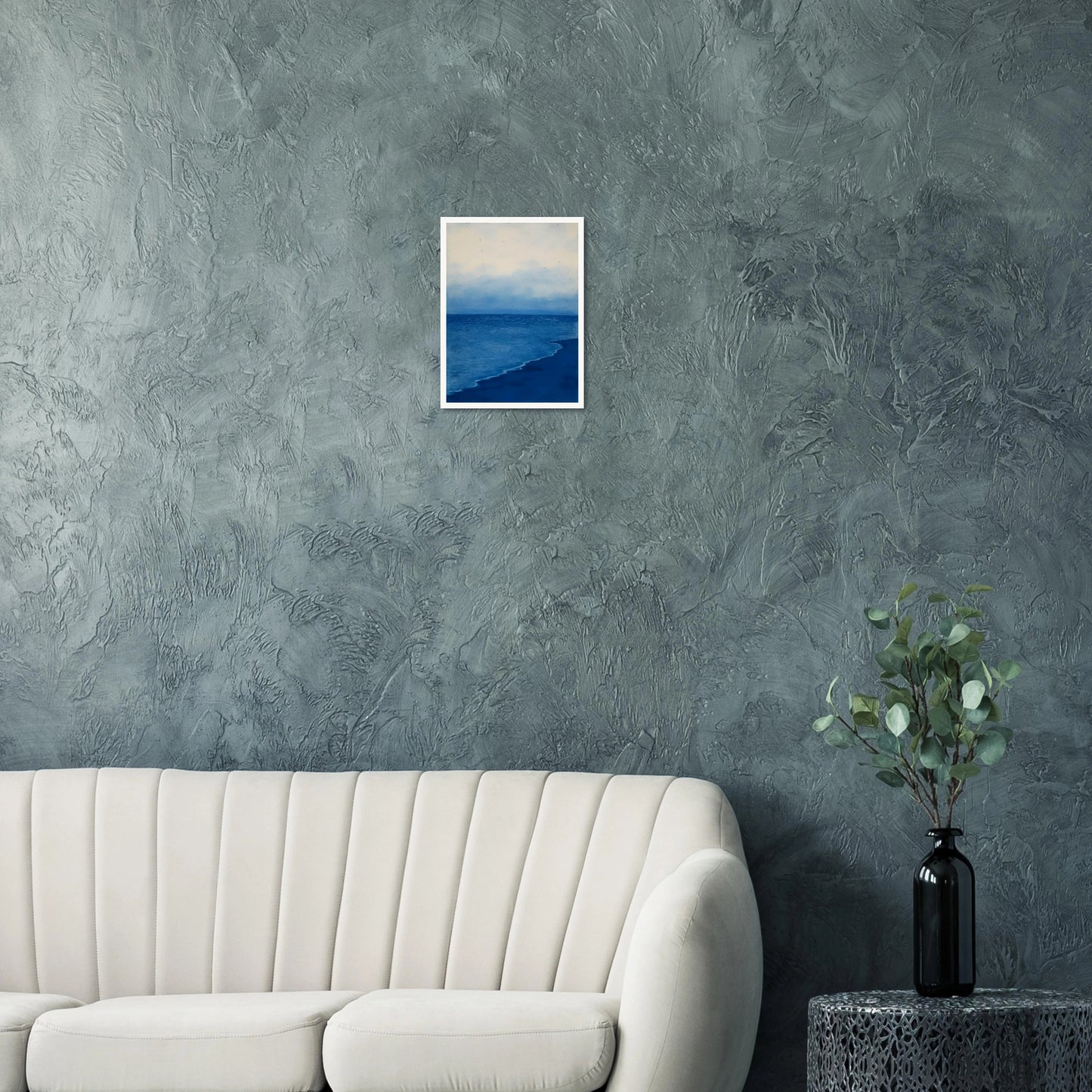 A calm, blue shoreline fades into the horizon under a soft, cloudy sky, evoking peace and solitude.
