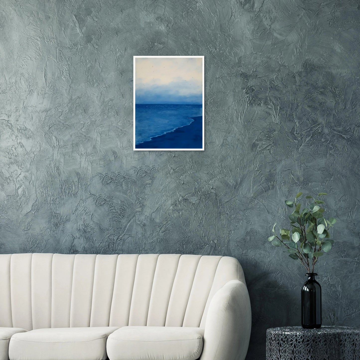 A calm, blue shoreline fades into the horizon under a soft, cloudy sky, evoking peace and solitude.