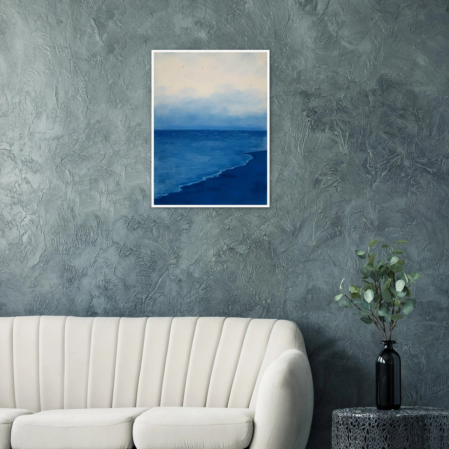 A calm, blue shoreline fades into the horizon under a soft, cloudy sky, evoking peace and solitude.
