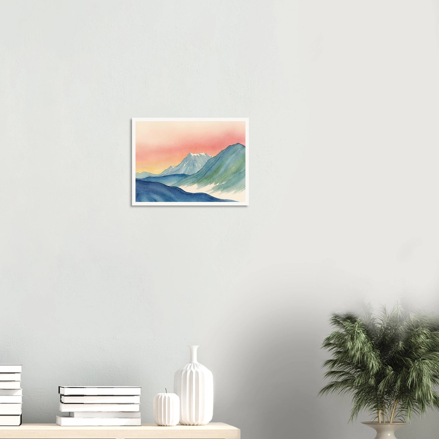 Cool-toned mountain ridges meet a radiant pink and yellow sky in this tranquil watercolor of a twilight alpine scene.