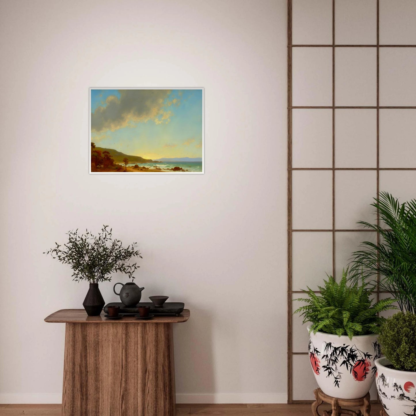 A sunlit coastal landscape with gentle waves meeting a golden shore, framed by rocky outcrops and distant hills under a vast sky.