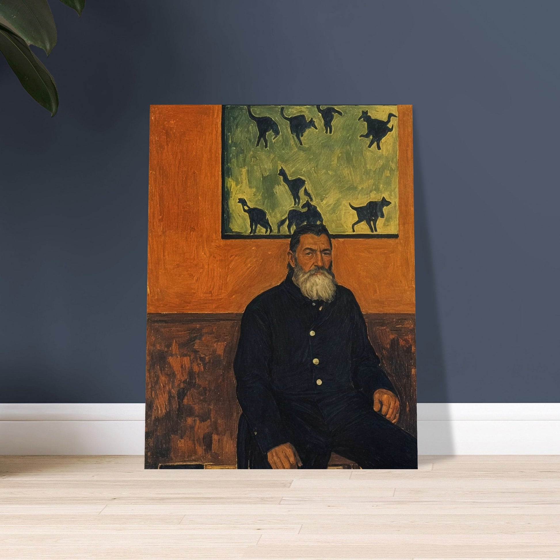 A bearded man seated against a burnt orange wall, gazing into the distance with a painting of cats behind him, exuding a quiet, contemplative presence.