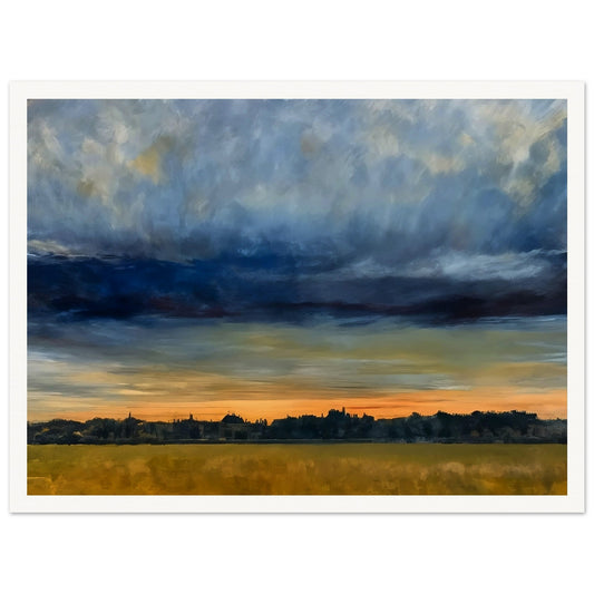 A distant cityscape under a dramatic sky at dusk, with the horizon glowing orange and a vast field in the foreground.