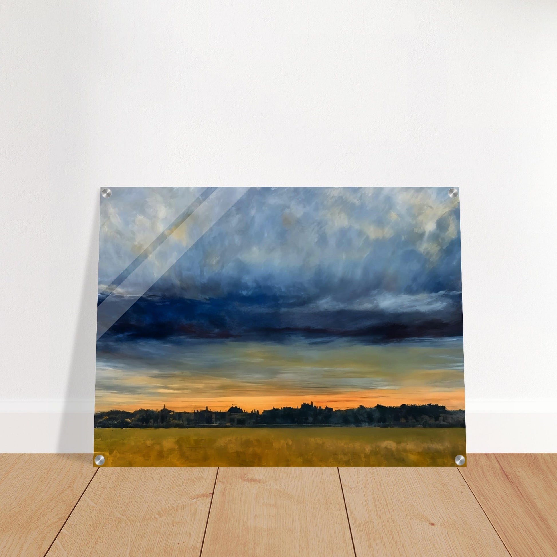 A distant cityscape under a dramatic sky at dusk, with the horizon glowing orange and a vast field in the foreground.