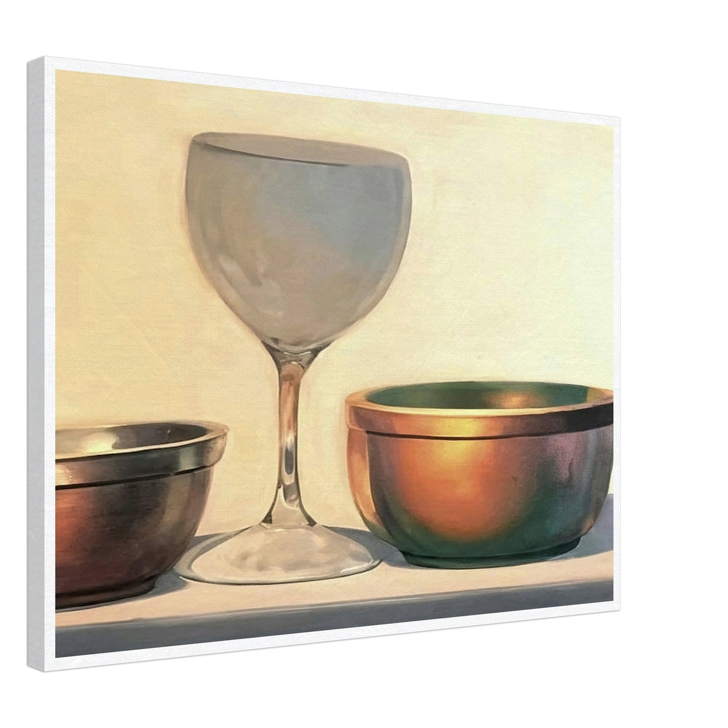 A glass chalice and two metallic bowls arranged in soft light, highlighting their reflective surfaces in a subtle, elegant composition.