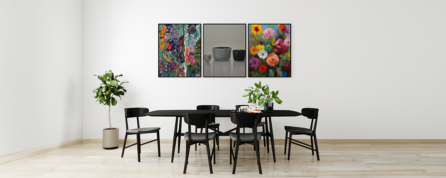 Modern dining room with a black table and chairs, decorated with a triptych of colorful floral and minimalist ceramic artwork on the wall, and a potted plant.