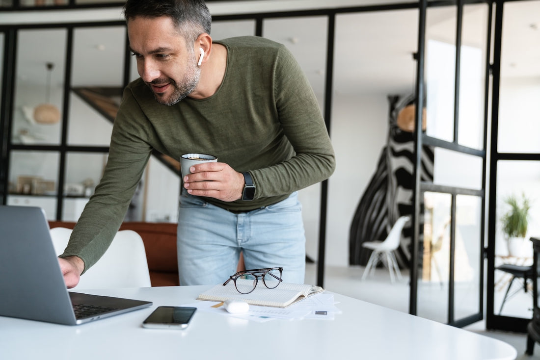 A man sitting in his home office without artwork to boost his productivity