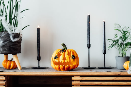 Halloween decor with jack o lantern and black candles