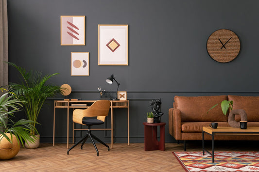 A cozy office interior with mid-century wall art and potted plants