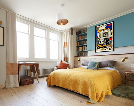 Bright bedroom with a yellow bedspread and bookshelves