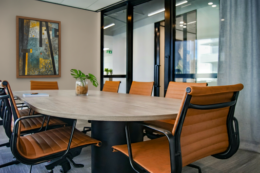 Conference room with wooden table and brown chairs