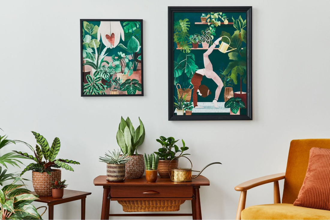 Spring wall artwork hung above a table with plants on display