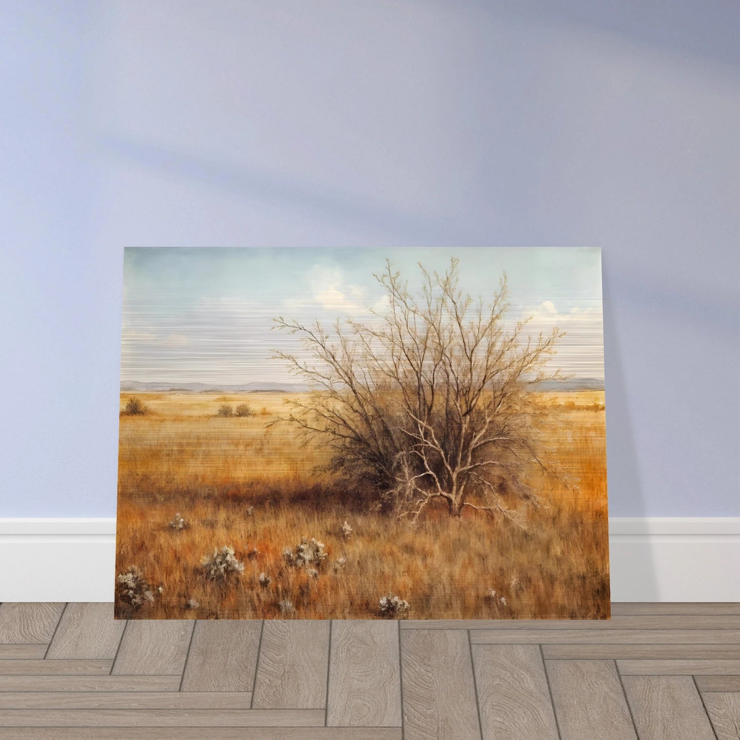 A golden-brown field stretches into the distance under a pale blue sky, with a single dry bush standing in quiet solitude.