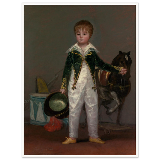 A young boy in a formal white costume holds a hat beside a toy horse, drum, and military play objects.