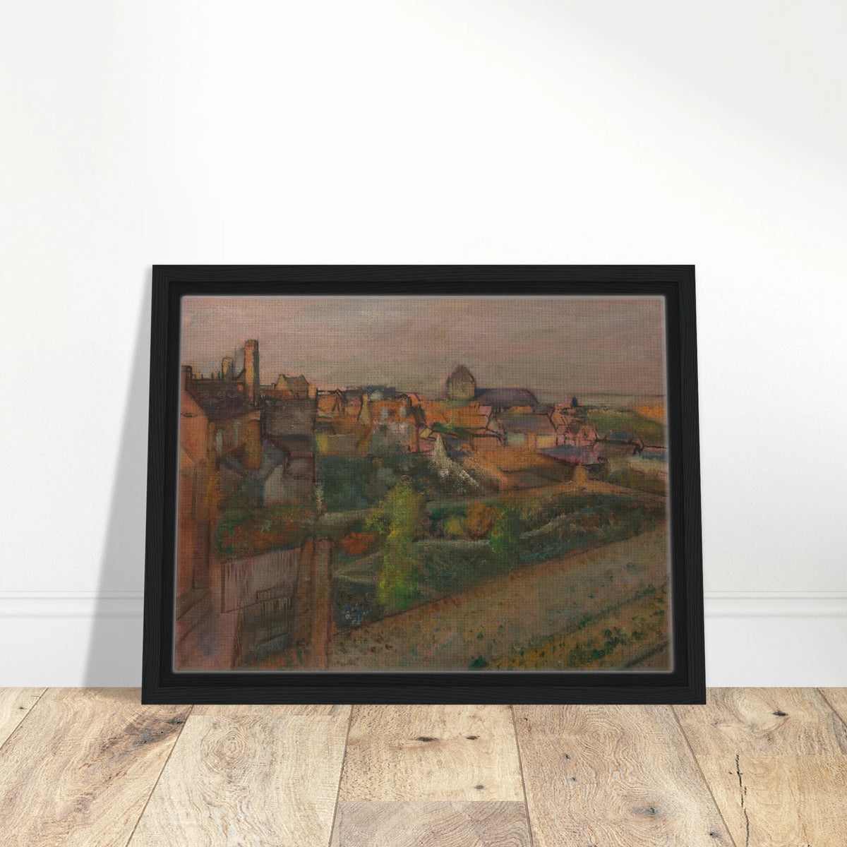 A high view of Saint-Valéry-sur-Somme with rooftops, gardens, and distant water under a pale sky.