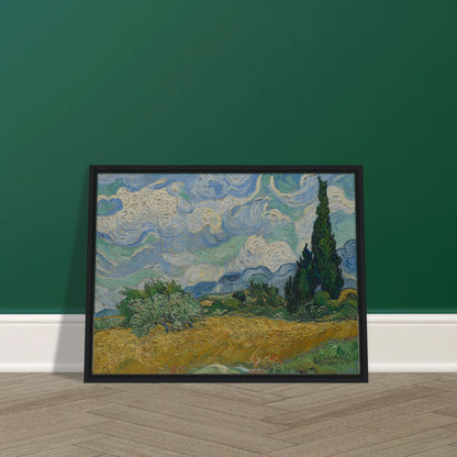 Golden wheat field and dark cypress trees beneath swirling blue-and-white clouds in a vivid Provençal landscape.