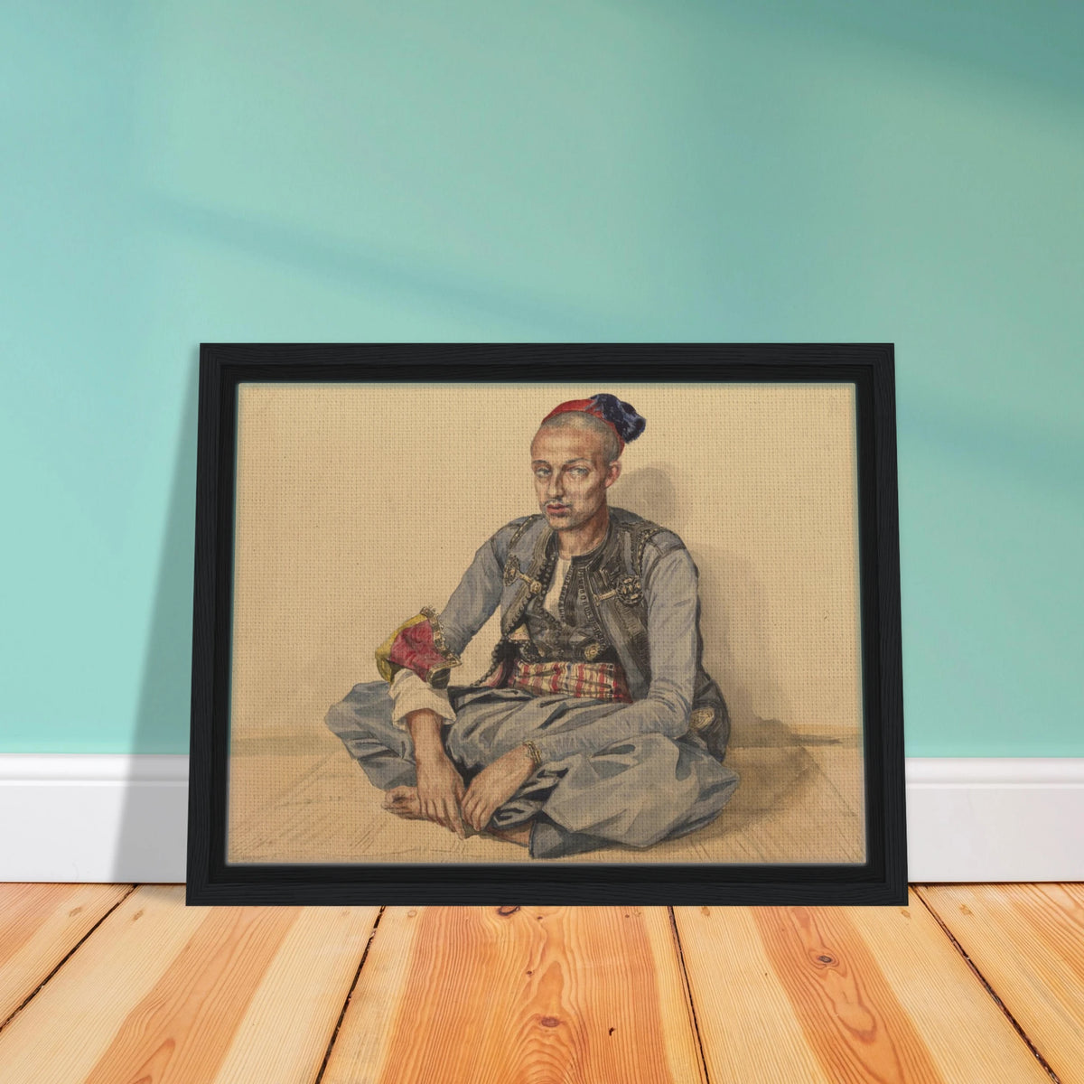 Seated artisan from Algiers in blue robes and a red cap, wearing a patterned sash and ornate accessories.