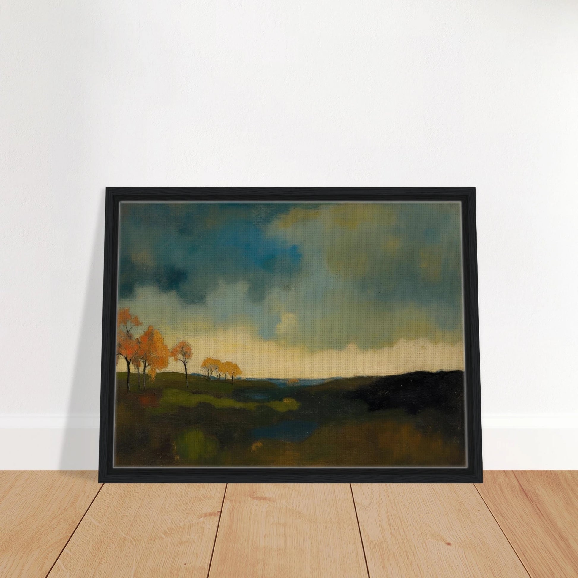 Golden autumn trees stand beneath heavy blue-gray clouds over dark rolling fields.