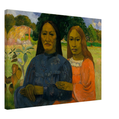 Two Tahitian women sit closely together in colorful dresses against a lush green landscape.