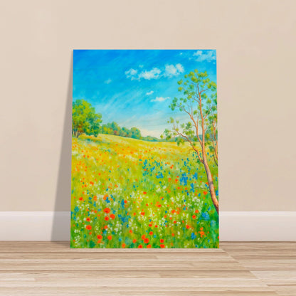 Bright wildflower meadow under clear blue sky with delicate trees, colorful blossoms, and sunlit greenery stretching across a serene spring landscape.