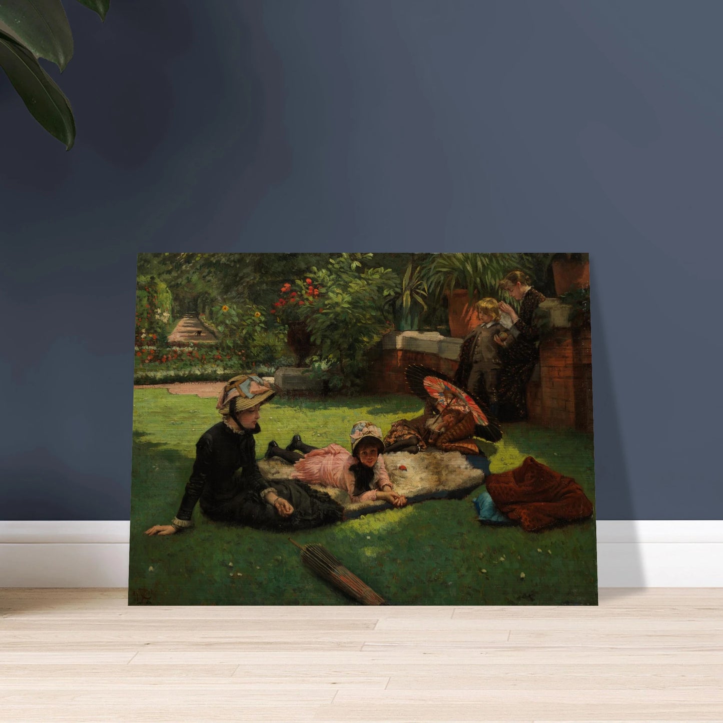Children and women lounge in a garden with a colorful parasol under bright sunlight