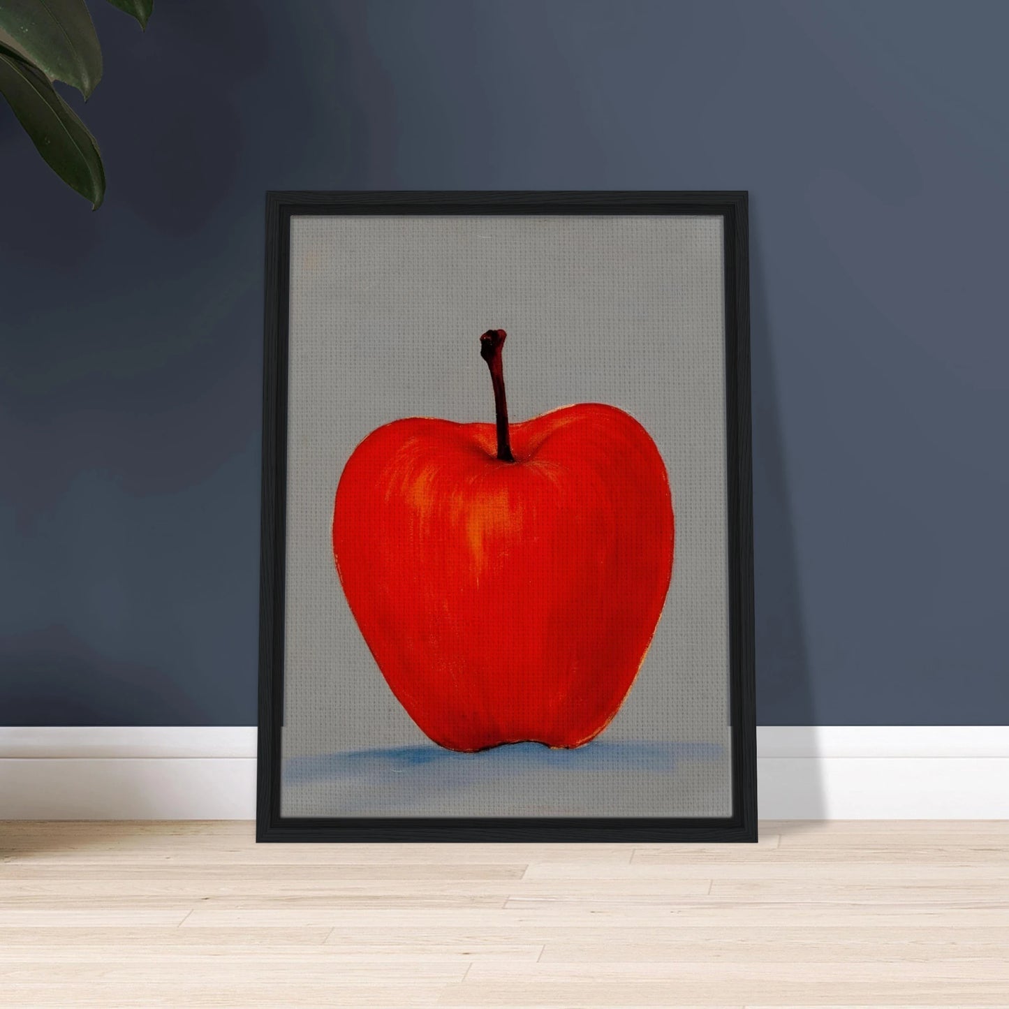 A vivid red apple stands alone against a muted gray backdrop, its glowing form balancing simplicity, boldness, and quiet elegance.