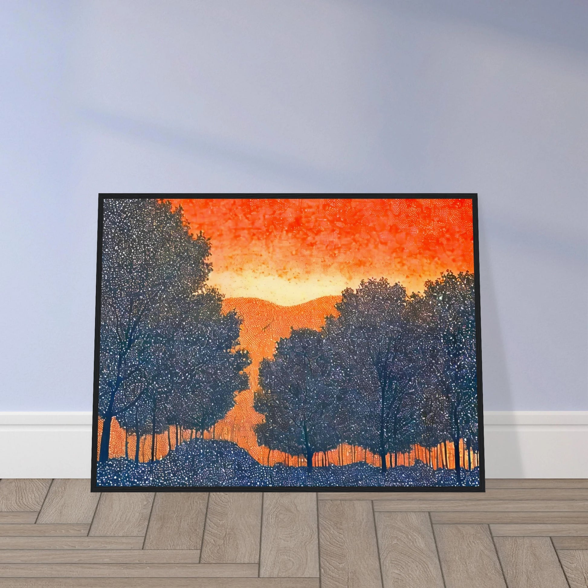 Silhouettes of trees in deep blue frame a vivid orange sky, evoking a fiery sunset over quiet hills dotted with tiny white specks.