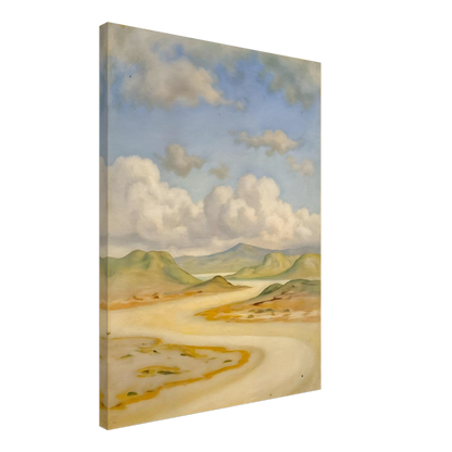 Soft clouds drift above pale hills, sandy curves, and quiet water under a blue sky.