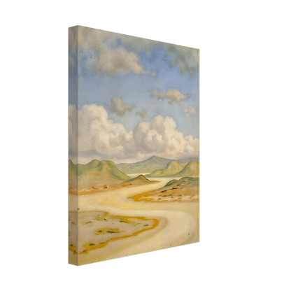 Soft clouds drift above pale hills, sandy curves, and quiet water under a blue sky.