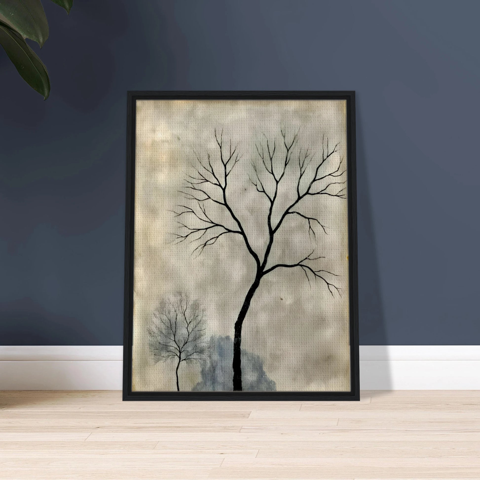 Two leafless trees stand silhouetted against a misty gray sky, evoking a quiet, contemplative atmosphere.