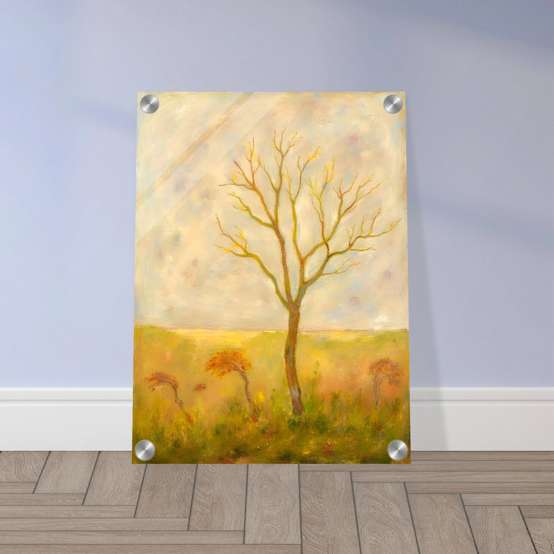 A lone tree stands tall in a golden meadow under a pale sky, its bare branches reaching gracefully toward the light.