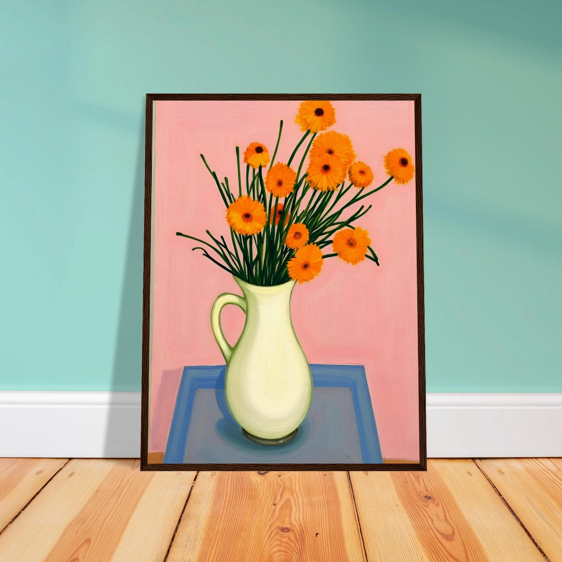 A vase of orange daisies with green stems against a soft pink background, radiating warmth and joy on a pastel tabletop.