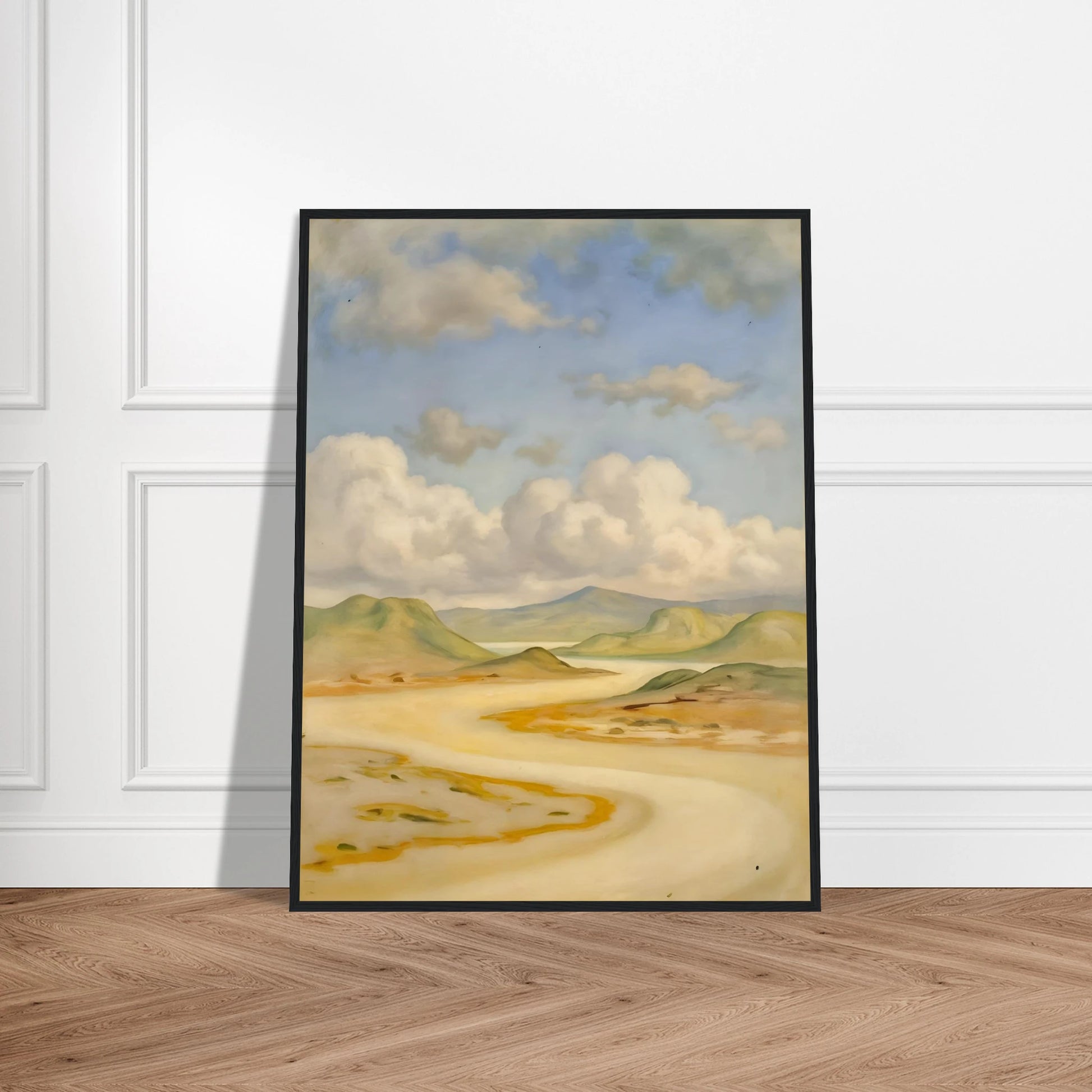 Soft clouds drift above pale hills, sandy curves, and quiet water under a blue sky.