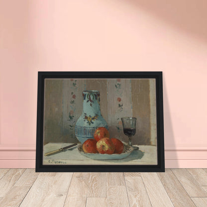 Apples on a plate with a blue pitcher, wine glass, and knife before floral wallpaper.