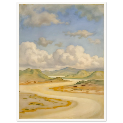 Soft clouds drift above pale hills, sandy curves, and quiet water under a blue sky.