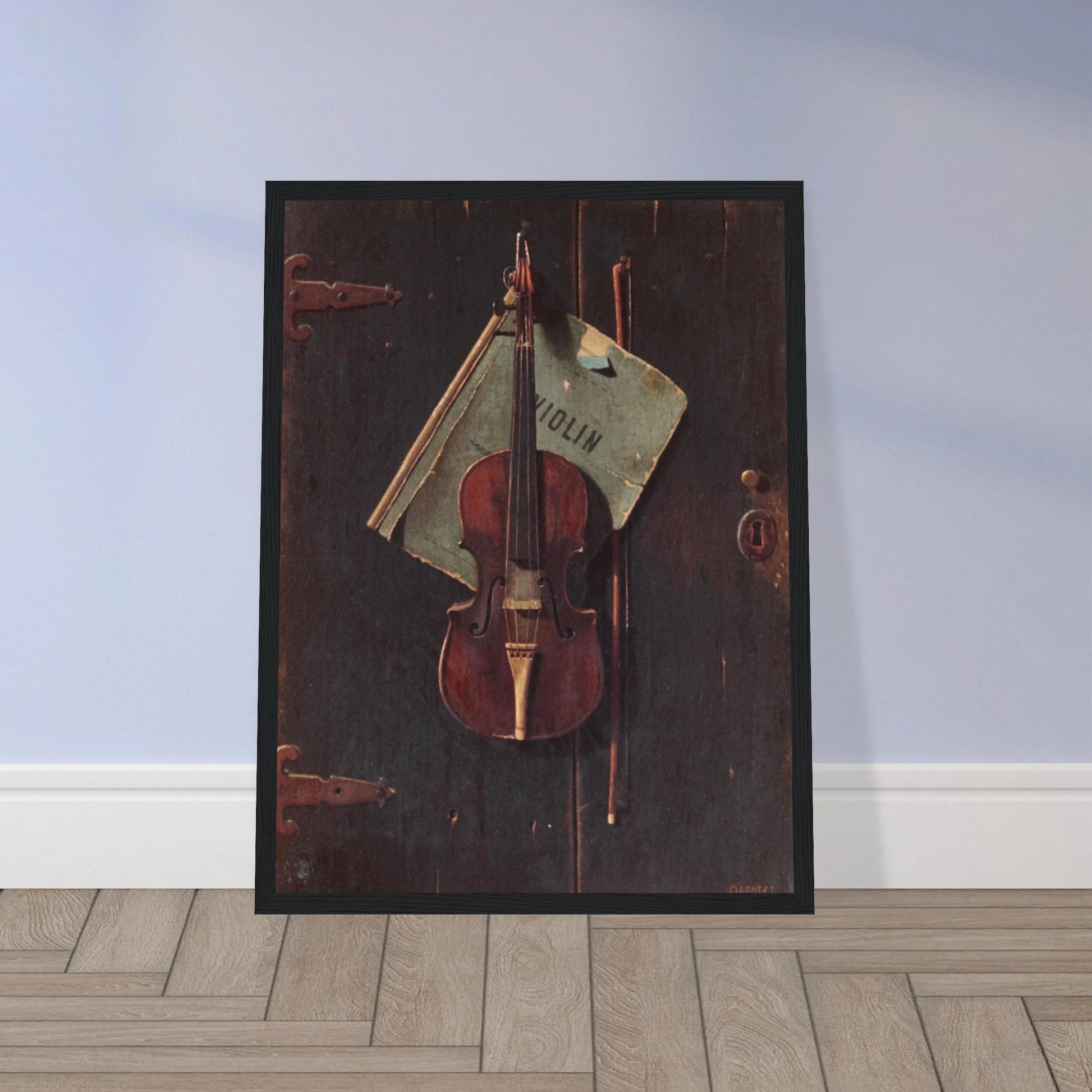 Violin and bow hang against a dark wooden door with a faded paper behind them