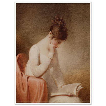 A young woman in a white dress rests her cheek on her hand while reading an open book beside a red chair.