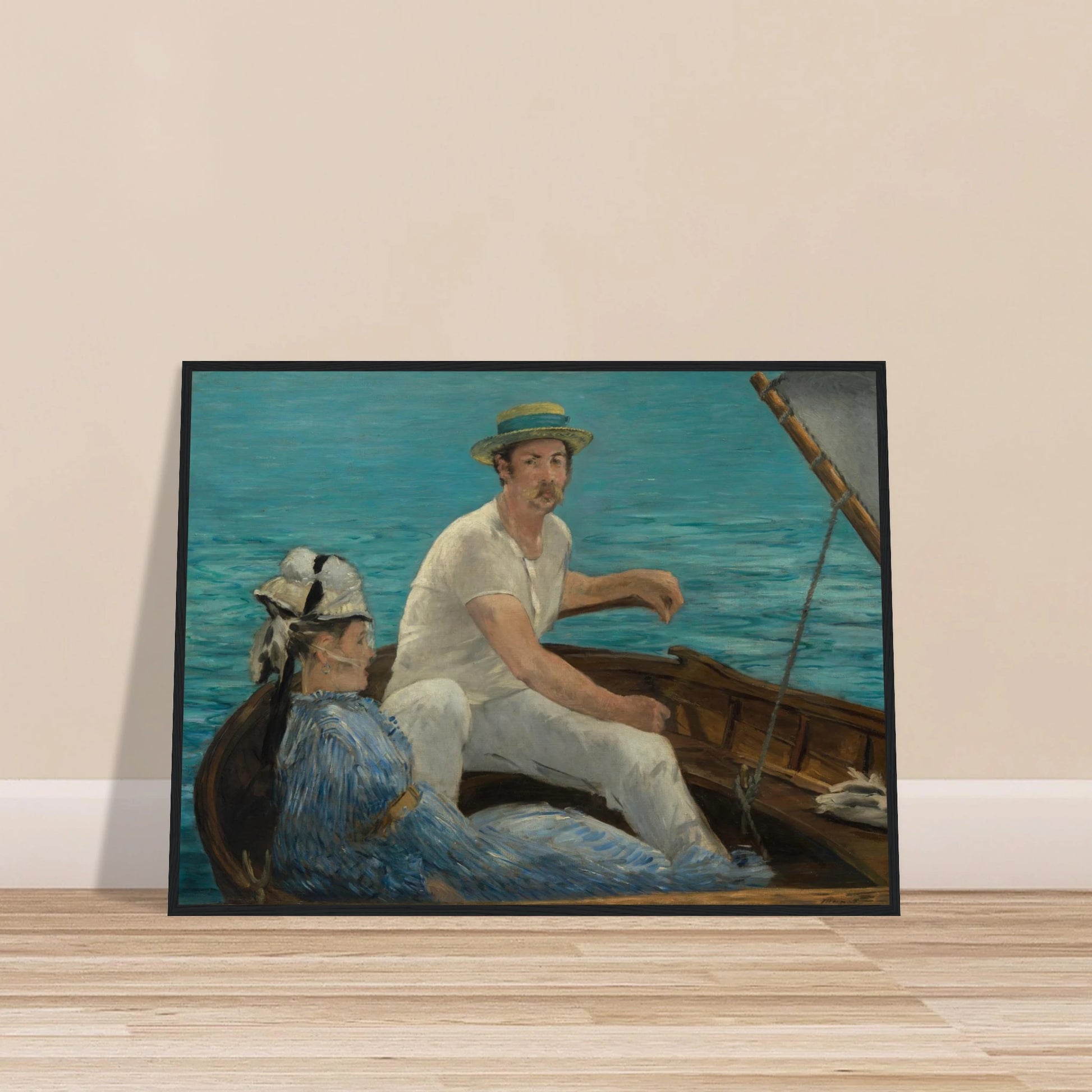 Man and woman sit in a small boat on bright blue water under a gray sail