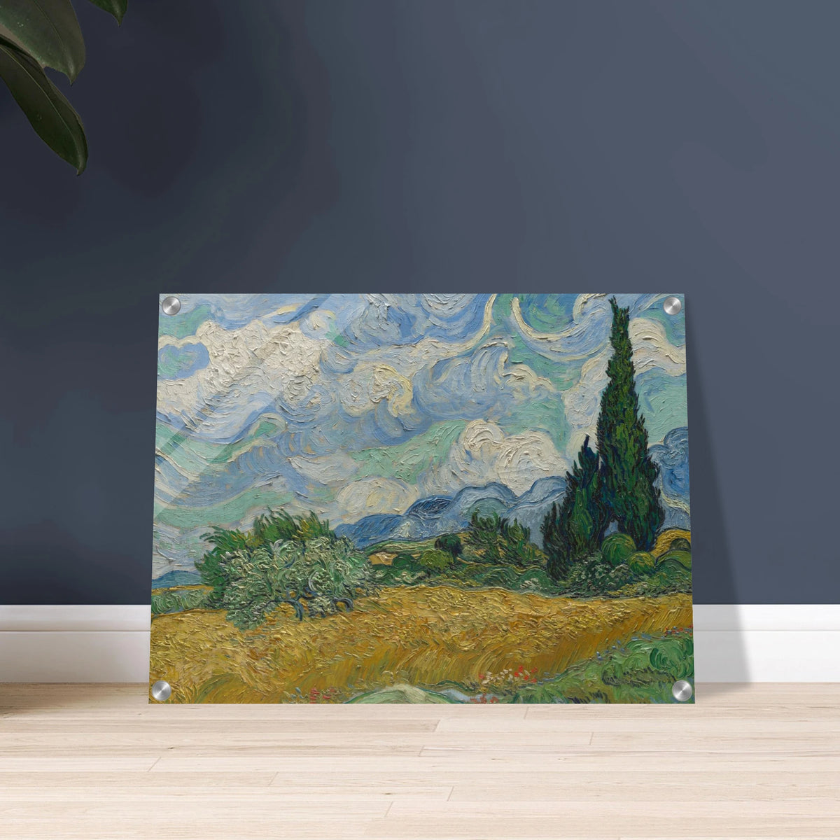 Golden wheat field and dark cypress trees beneath swirling blue-and-white clouds in a vivid Provençal landscape.